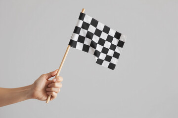Obraz premium checkered race flag in hand.