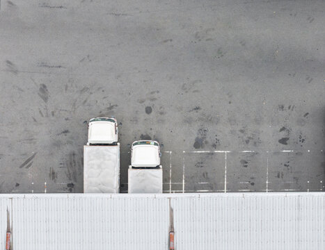 Aerial View of Delivery Trucks at Warehouse Parking Lot