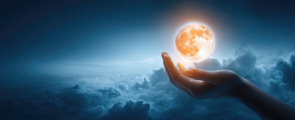 Human hand holding glowing orange sun sphere with bright light rays