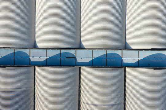 Aerial view of curved metal roofs of industrial warehouse buildings