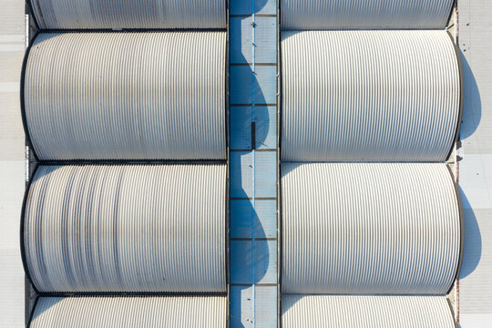 Aerial view of curved metal roofs of industrial warehouse buildings