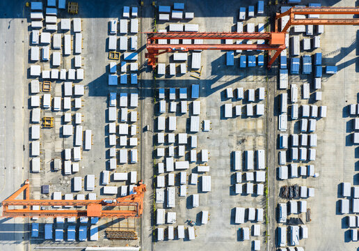 Aerial view of industrial yard with cranes and concrete blocks