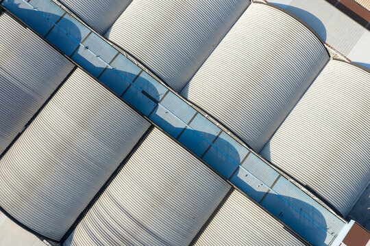 Aerial view of curved metal roofs of industrial warehouse buildings