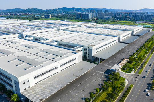 Aerial view of modern industrial warehouse and surrounding road