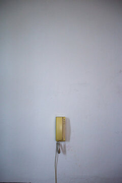 Telephone receiver hanging on a wall