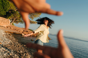 Young woman dancing at the beach portrait