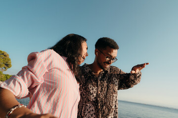 Best friends dancing with energy outdoors by the sea