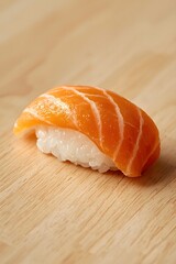 Fresh handcrafted salmon nigiri sushi presented on a clean wooden surface with soft lighting, showcasing premium fish texture and minimalist Japanese cuisine aesthetic