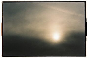 Vivid sunset hidden behind clouds creates a dramatic atmosphere 