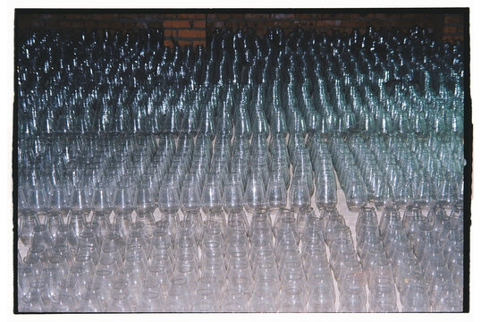 Glass bottles arranged in neat rows showing various shapes and sizes