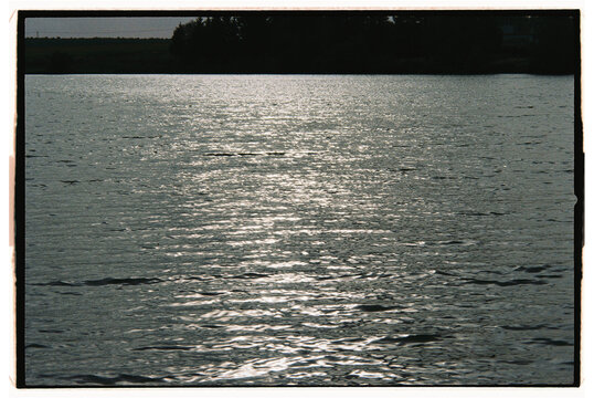Sunlight reflecting on calm water during evening hours