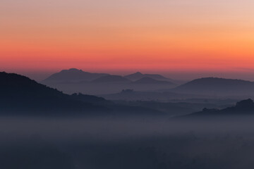 Aerial view in the morning, mountains crisscrossing the stunning red-orange sky, Chumphon Province, Thailand.
