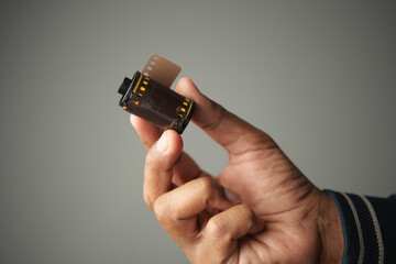 Holding a film roll in hand for photography enthusiasts