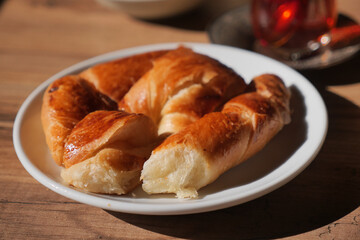 Freshly baked croissants on a white plate