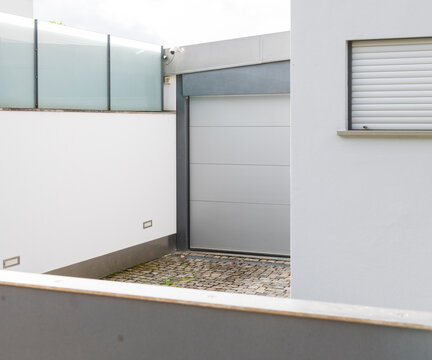 Modern Gray Sectional Garage Door White House Exterior