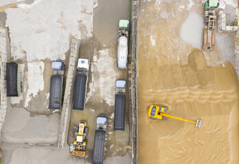 Aerial View of Trucks and Excavator in Sand Yard