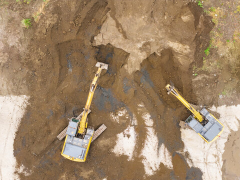 Aerial View of Yellow Excavators Working on Construction Site