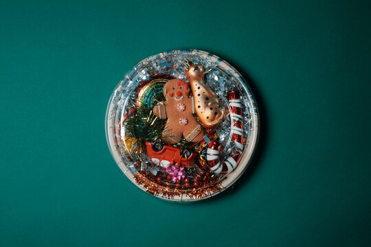 a festive circular box filled with christmas ornament seen from above