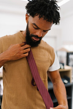 Man Adjusting Tie in Dublin Clothing Store During Summer