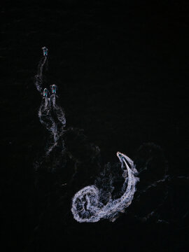 Top view of jet ski tracing patterns in water

