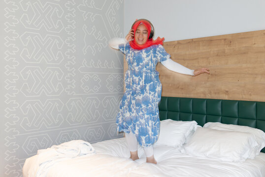 Woman jumping on the bed
