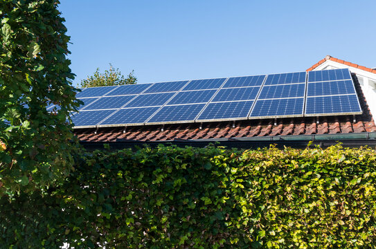 Solar Panels on Residential Rooftop with Blue Sky