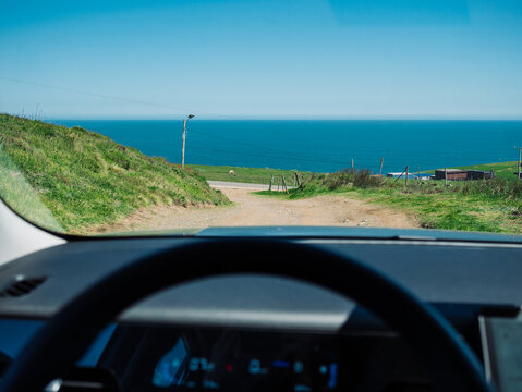Driving in a rural Pacific coast landscape