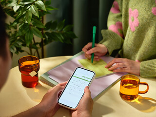 Two individuals working together to plan daily tasks