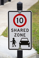 Street sign indicating a 10 kilometre speed limit and shared use traffic zone