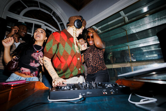 Diverse friends dancing and enjoying live dj music