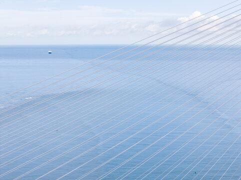 Cable Stayed Bridge Over Blue Ocean With Geometric Lines
