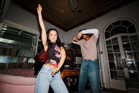 Young people dancing having fun at house party