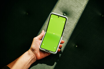 Mock-up phone with empty screen on green leather background
