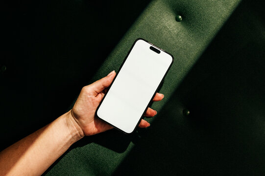 Mock-up phone with empty screen on green leather background