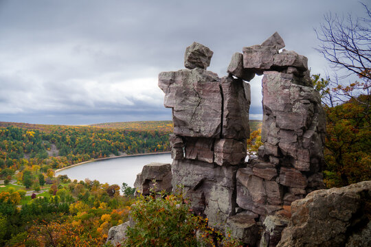 Devil's Doorway natural rock arch formation overlooking Devil's Lake State Park in Baraboo, Wisconsin, during peak fall autumn colors