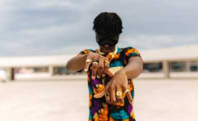 Close-up of hands with rings and fashion shirt
