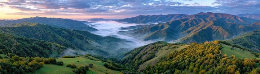 Fototapeta premium A misty mountain range beneath cloudy sky concept. A breathtaking view of rolling hills covered in lush greenery.
