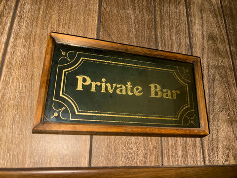 Vintage Wood Paneling with Private Bar Sign 