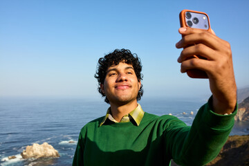 Man takes a selfie on a rocky shore