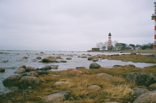 Lighthouses Stand by the Rocky Shore Under a Cloudy Sky