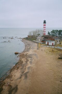 Coastal View With a Lighthouse and Sandy Beach at Sunrise