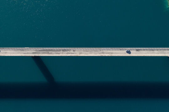 top view of a Long Bridge Stretching Over Calm Blue Waters