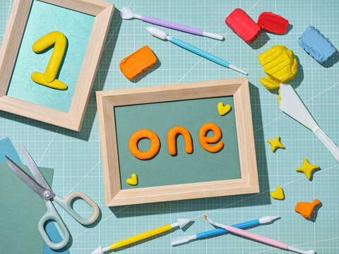Creative composition with numbers and the word 'one' made of clay.