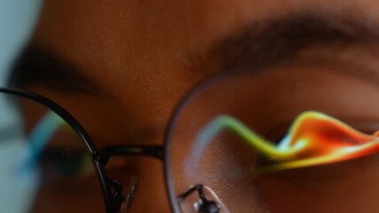 A person wearing glasses uses a laptop as real-time dynamic digital data waves reflect on the lenses, symbolizing analytics, forecasting, fintech, decision-making, and digital intelligence.
- Powered by Adobe