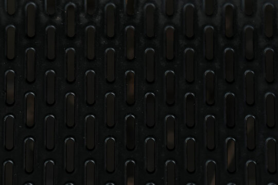 Black metal perforated grid texture background