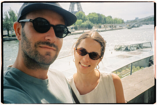 Analog self-portrait of a couple walking through Paris