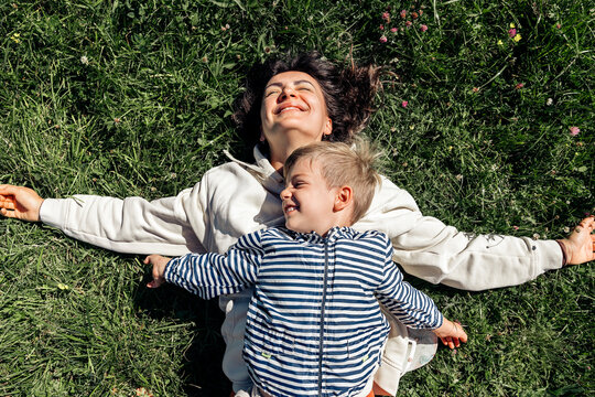 Mother and son relaxing on grass together