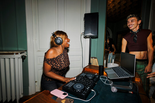 Female dj playing music at happy party