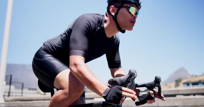 Cyclist, bike and fitness with man in city for triathlon training, workout and sports. Cardio challenge, wellness and cycling athlete with person outdoor for exercise, health and race commitment