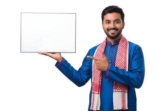 Smiling Indian man in traditional ethnic attire holding and pointing at a blank whiteboard isolated on white background, suitable for festival promotions, product ads, announcements, and marketing 